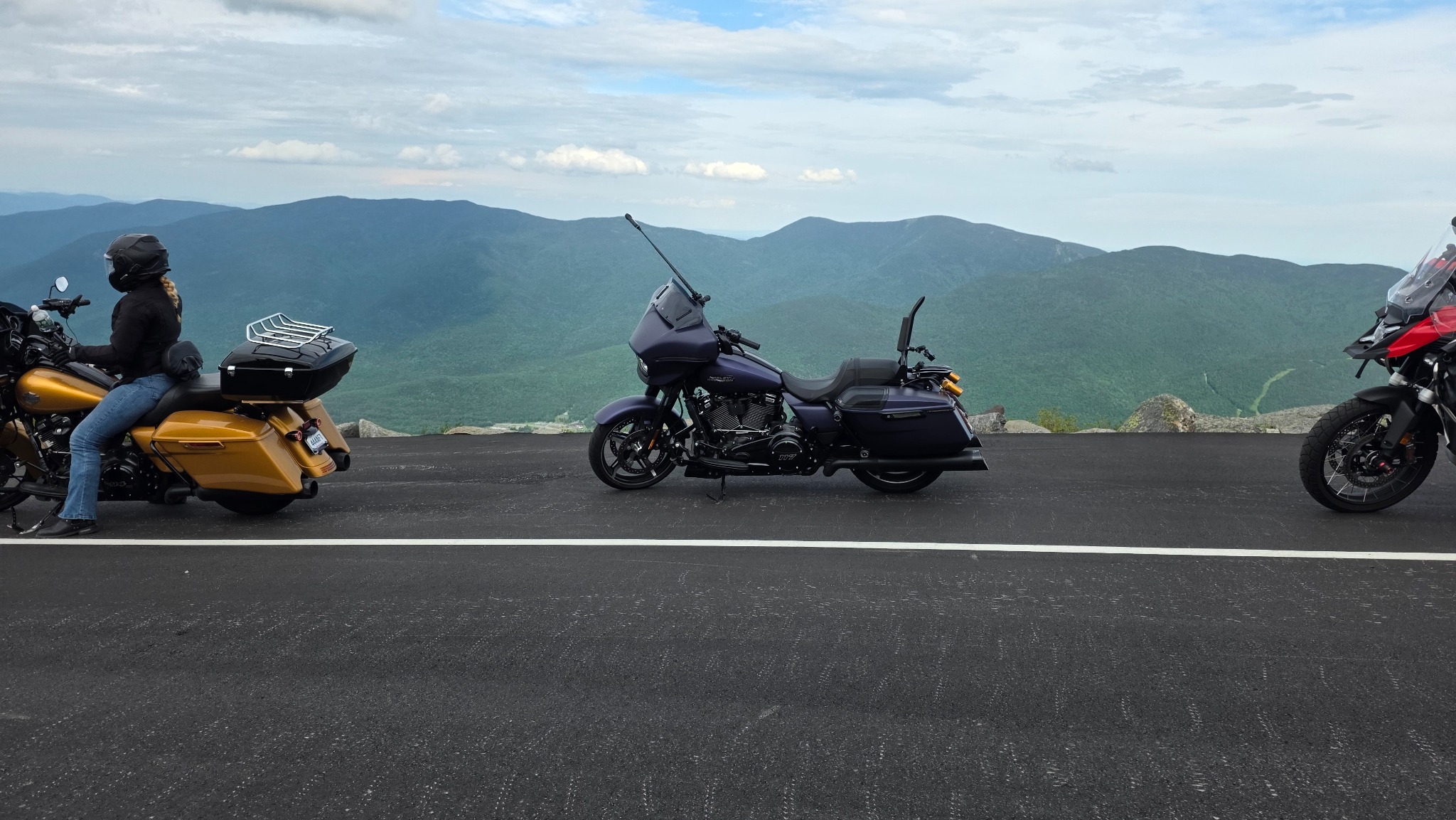 Motorcycles parked along a mountain overlook